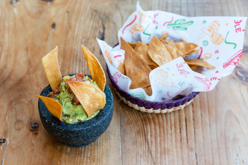 Inside a Guzman y Gomez restaurant with vibrant Mexican decor